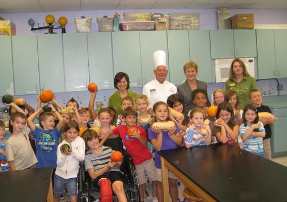 Deputy Under Secretary Janey Thornton (center right) and American Culinary Federation Chef David S. Bearl (center left) pose with RB Hunt Elementary first graders from Christine Skipp’s and Lori Hall’s class as they show off pumpkins. Thornton and Bearl visited the school located in St. Augustine, Fla., on Oct 18, to celebrate Farm to School Month and First Lady Michelle Obama’s Let’s Move! Chefs Move to Schools initiative. The pumpkins were harvested from the University of Florida’s Institute of Food and A