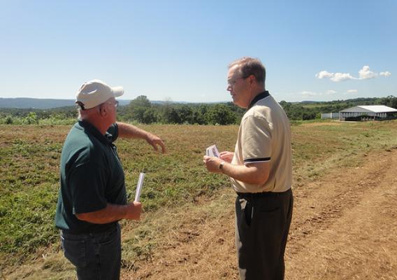 Mac Curtis (left), owner of Windview Farm in Port Treverton, explains to Rural Development Under Secretary Dallas Tonsager how his farm has benefited from the promising technology of a poultry litter incinerator that reduces his energy costs and the amount of nutrients flowing into the Chesapeake Bay.