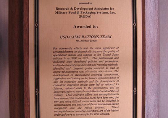 A photograph of the Colonel Rohland Isker Award given to the USDA/AMS Rations Team.  Members of the USDA staff are being recognized for their efforts to ensure only top quality products reach our troops. 