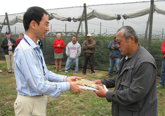 Katsuhiro Saka of Japan (left) thanks Steve Sakuma (right) of Sakuma Brothers Farms for hosting the tour at his fruit operation.  Steve raises strawberries, raspberries, and blueberries.