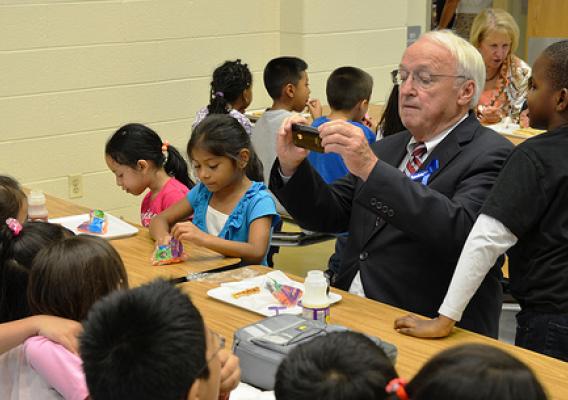 Under Secretary Kevin Concannon takes a photo of his lunch mates last month at Arcola Elementary School in Silver Spring, Md.  Concannon presented all 132 Montgomery County Elementary Schools with Healthier US Schools Challenge Bronze awards.