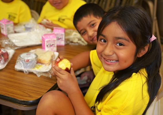 A youngster enjoys a crisp apple for lunch at the Puerto Rican Association for Human Development’s Mi Escuelita summer food program site in Perth Amboy, New Jersey. More than 75 kids enjoy physical activities such as soccer and basketball followed by a free healthy lunch each day during summer thanks to the USDA Summer Food Service Program.