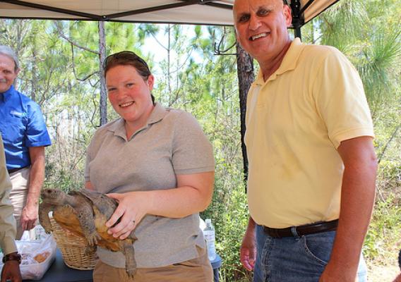 Julie Grogan-Brown and Al Garner, both with NRCS, meet a gopher tortoise, one of the threatened species that call longleaf pine forests home. 