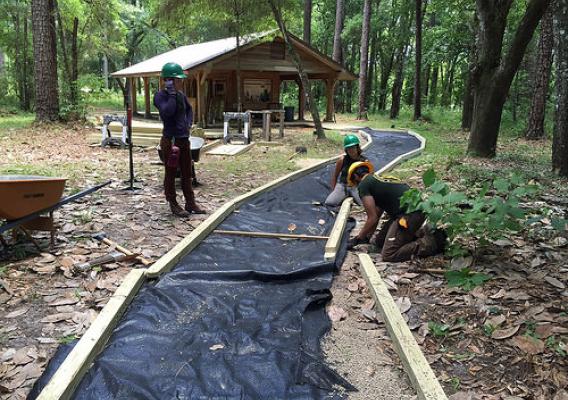 Youth workers constructing an Architectural Barriers Act Accessibility-compliant trail