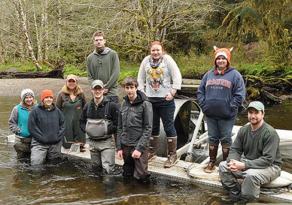 The Twelvemile Creek restoration monitoring crew and Fish Tech Boot Camp students and instructors posing for a photo in front of a screw trap