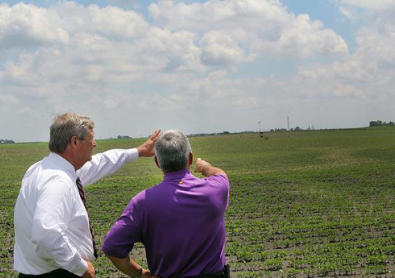 Agriculture Secretary Tom Vilsack listening to U.S. Department of Agriculture (USDA) Agricultural Research Service (ARS) supervisory plant physiologist Dr. Jerry Hatfield explain the equipment to gather information on climate changes and impacts on corn and soybean plants in Iowa