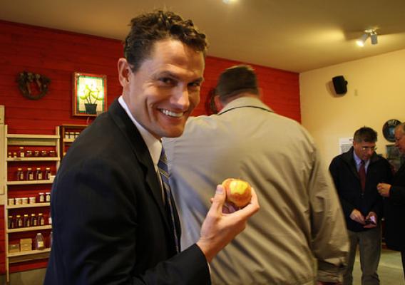 USDA Rural Business Services Administrator Sam Rikkers enjoys a honey crisp apple from Leffel Roots Orchard in Eau Claire, Wisconsin