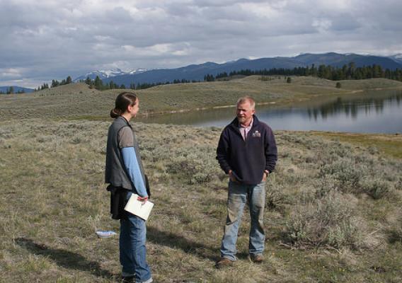Jim Stone, Montana Rancher, and Bridget Collins, former Association of Fish and Wildlife Agencies Agriculture Policy Coordinator, discuss conservation programs near Jones Lake on the Rolling Stone Ranch. Photo by Dave Smith.