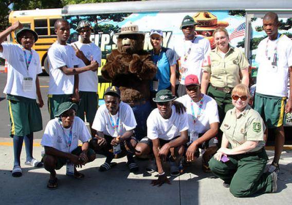 Smokey Bear and U.S. Forest Service employees pose for a picture with the South African team at the World Special Olympics