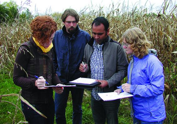 Dr. Morton (R) and her colleagues looking at the layout of one of the more than 35 field sites they are gathering data on