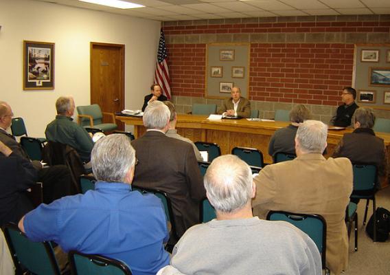 Iowa USDA Rural Development State Director Bill Menner (center, seated) and other federal officials, hold a roundtable meeting in Ogden, Iowa.