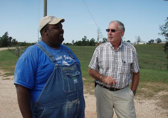 Cattle and poultry farmer Anthony Lovett and Supervisory District Conservationist Ron Read monitor the success of conservation practices, such as the incinerator and cross-fencing, on his Jasper County farm.