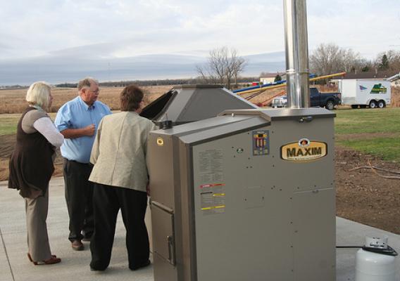 USDA Business & Cooperative Program Director Dana Kleinsasser(left), Area Specialist Darlene Bresson, and Legend Seeds President Glen Davis check out the biomass boiler system, which saves 60 percent of the cost of heating the seed company building, compared to the previous system.