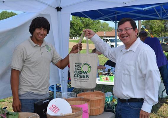 Crow Creek Fresh Food Initiative employee Wyatt Fleury at the Farmer’s Market with Kevin Yellow Bird Steele.  With USDA support, a Farmers market is thriving in Ft. Thompson.  