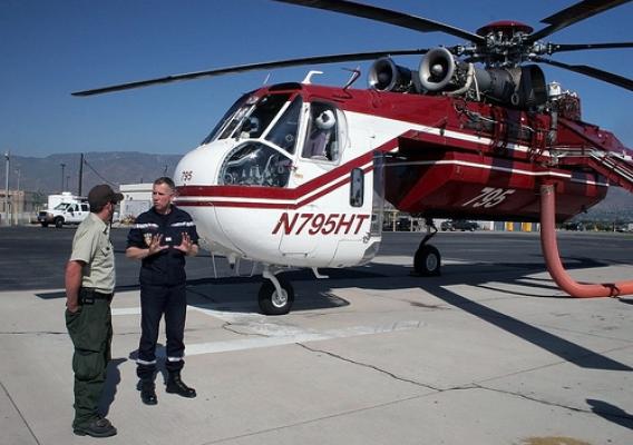French firefighters learn from California visit. Capt. Philippe DelQuie talks with Helitanker Superintendent  Rocco Terracciano at the San Bernardino Air Tanker Base. USFS photo.