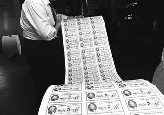 A Bureau of Printing and Engraving employee examines a run of food stamps for the U.S. Department of Agriculture for errors in May 1974. Photo courtesy National Archives and Records Administration.