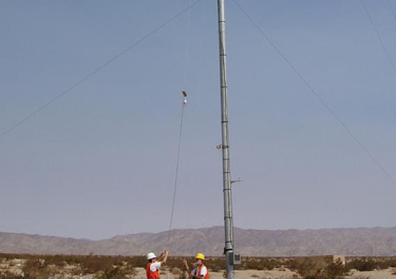 Forest Service staff installing bat echolocation detector on meteorological tower Photo by Ted Weller.