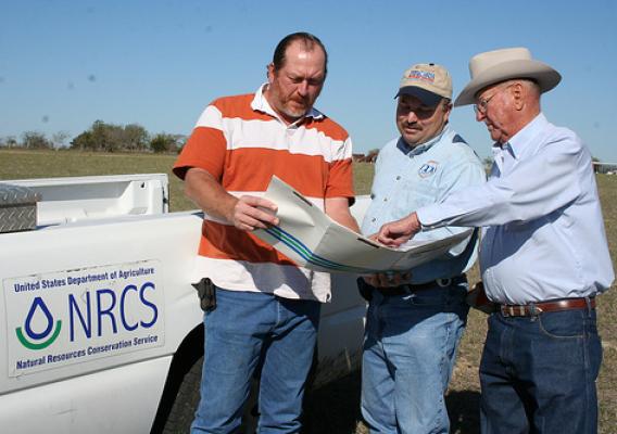 NRCS Civil Engineering Technician, Minzenmeyer and Fayette County SWCD technician, Milton Koenning visit with David Brooks about his conservation plan for continuing improvements on the ranch. 