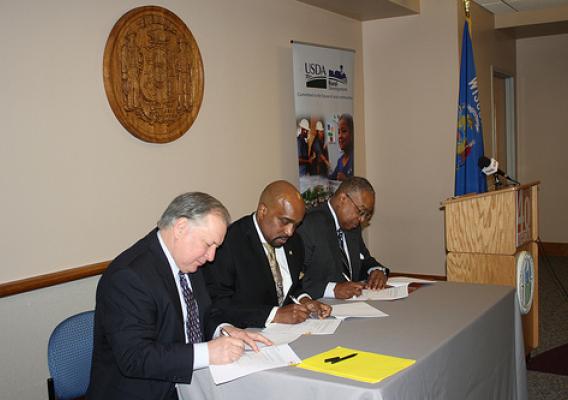 USDA Rural Development State Director, Stan Gruszynski (left) signs the Subsidy Layering Review MOU agreement with WHEDA Executive Director, Wyman Winston; and HUD Midwest Regional Administrator, Antonio Riley at the WHEDA Offices in Madison, WI on February 27, 2012.