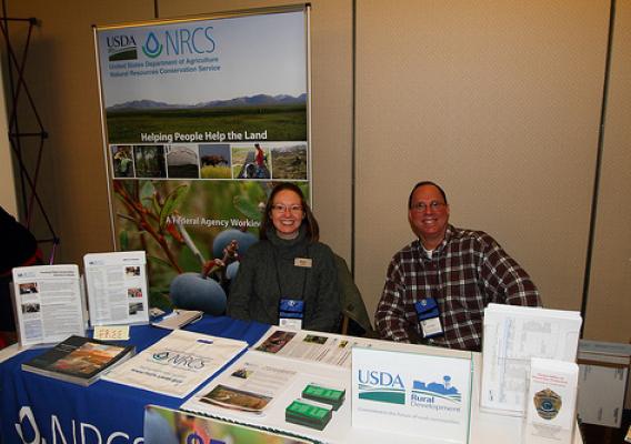 Molly Voeller, Public Affairs Specialist for the Natural Resources Conservation Service in Alaska and Larry Yerich, Public Information Coordinator for USDA Rural Development-Alaska provide agency program and service information to participants and vendors. Photo courtesy of Doug Lindstrand. 
