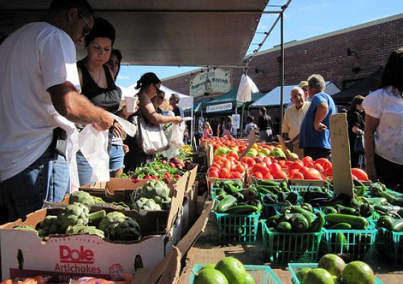 Customers scoop up a handful of the healthy, fresh produce available at one of the many farmers’ markets found in communities across America.