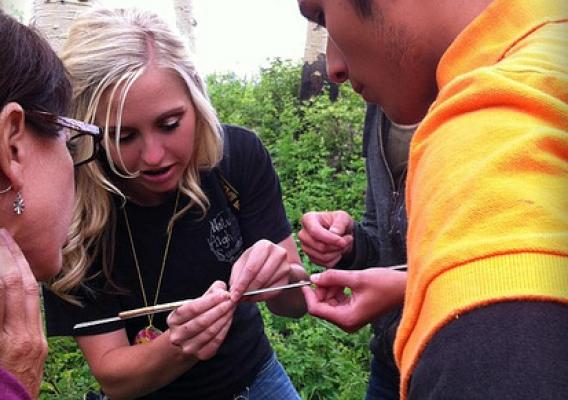 Sierra Hellstrom, Nature High Summer Camp director, explains to student about the core sample taken from an aspen tree.