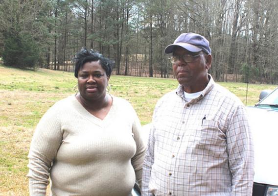 NRCS Supervisory District Conservationist Priscilla Williamson (left) worked with Charles McLaurin (right) to remove invasive grasses and install cross fencing, improving water quality downstream. NRCS photo.