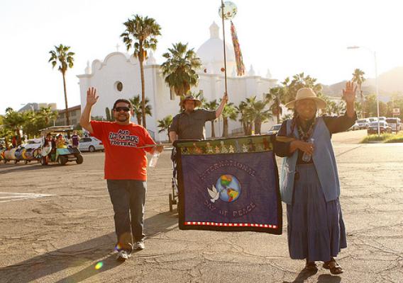 Ajo, Arizona’s Sonoran Desert Retreat Center recently received an ArtPlace grant to promote small town vitality. The town’s annual International Day of Peace parade brings together people from the Tohono O’odahm Nation and Sonoyta, Mexico.  Pictured here Eric Alegria (board chair of the Center), Lorraine Marquez Eiler of the Hla C-ed O’odham district on the Tohono O’odham Nation legislative Council, and (behind) Brian Mackenzie, the principal of the Ajo school. Photo courtesy of Tracy Taft.  