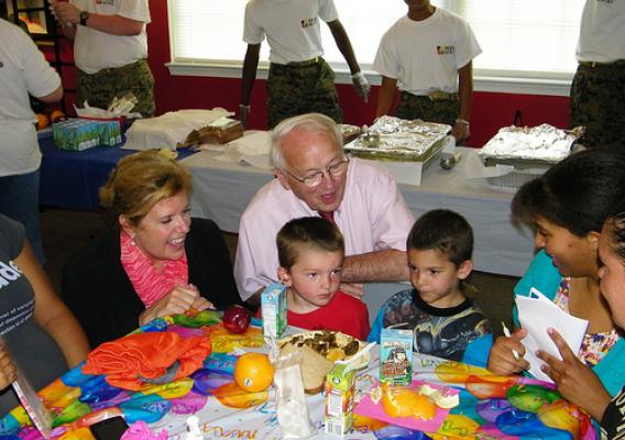 Food and Nutrition Undersecretary Kevin Concannon (kneeling) and RD RBS Administrator, Lillian Salerno (far left) share a funny moment with two young men participating in this year's FNS Summer Feeding Program.