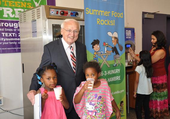 FNCS Under Secretary Kevin Concannon poses with kids drinking low-fat milk.