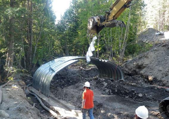 Workers replace a culvert with a larger one to accommodate higher water flows on the Colville National Forest (Photo Credit: USFS). 