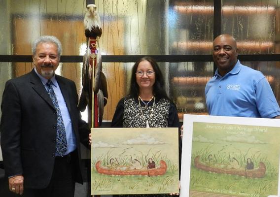 Larry Romanelli, with the Little River Band of Ottawa Indians Ogema (left) and NRCS Michigan State Conservationist Garry Lee (right) pose with artist Shirley M. Brauker, the winner of the agency’s Native American Heritage Month poster contest. NRCS photo.