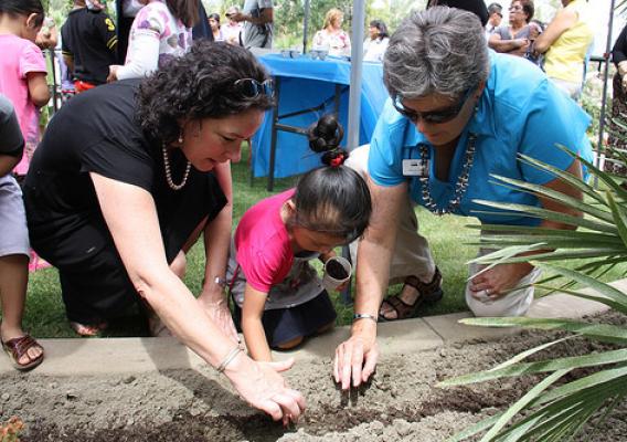 Deputy Under Secretary Patrice Kunesh (left) and California RD State Director Glenda Humiston join children and families to plant a community vegetable garden at Mountain View Estates.