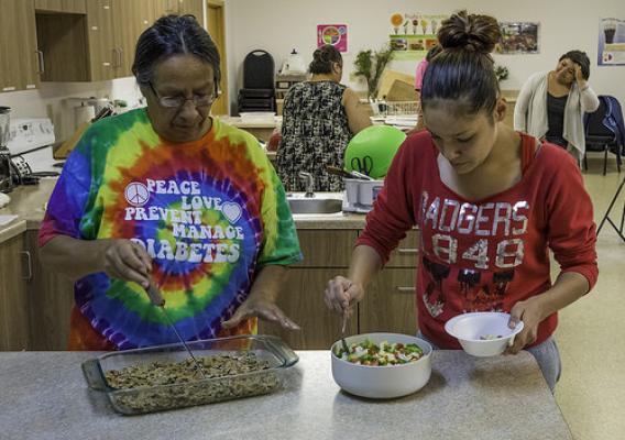 Participants in the Menominee Indian Tribe of Wisconsin’s monthly cooking class sample the new recipes they learned to prepare, cereal treats with wheat bran flakes and zippy zucchini salad. USDA Photo by Bob Nichols.