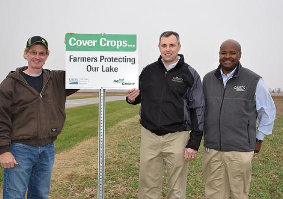 From left to right, Hardin County farmer Jerry McBride, AgCredit CEO Brian Ricker and Ohio State Conservationist Terry Cosby place the first cover crop sign in McBride’s cover crop field which contains a mix of oilseed radish, hairy vetch, and cereal rye. NRCS photo by Dianne Johnson.