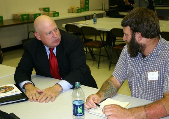 Jim Radintz (left) from the FSA Farm Loans Programs met one-on-one with producers to educate them about microloans and other FSA loan opportunities.