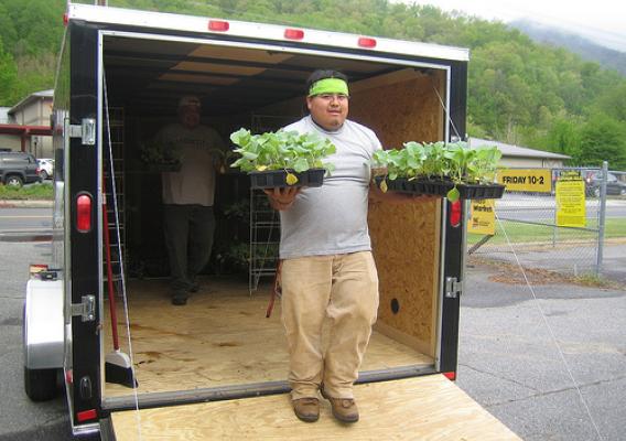 Volunteer George Welch unloads Garden Wagon plants.  
