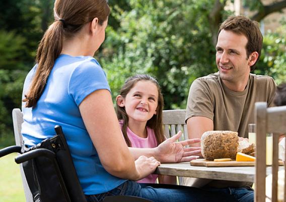 Family of three dines outdoors. ERS research found that among households that included an adult with a work-preventing disability, a third were food insecure in 2009-10.