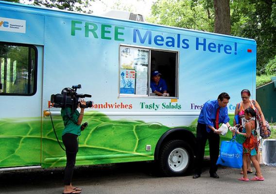 Northeast Regional Administrator, James Arena-DeRosa serves a meal from the NYC food truck at Orchard Beach in the Bronx.