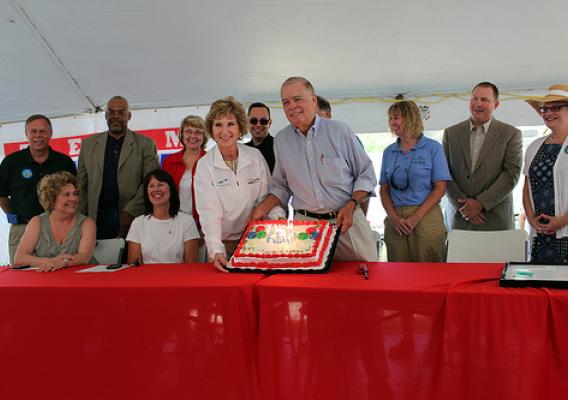 USDA and FAC members enjoy the cake with candles representing 150 years of service.