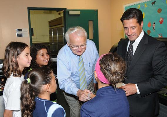 US Kevin Concannon and Miami-Dade County School Superintendent Alberto Carvalho talk with students from North Beach Elementary School, Miami, FL, on August 23, 2012, during lunch.  (USDA photo by Debbie Smoot).