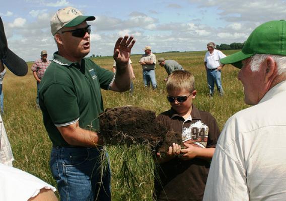 In this photo from the 2009 Society for Range Management (SRM) Award tour, Soil Quality Specialist, Rick Bednarek, formerly of SD, explained the darkness of the soil was due to the organic matter which is the key indicator of the health of soil.