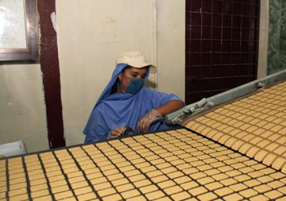 A Bangladeshi factory worker monitors the production of biscuits made from U.S. donated wheat. The donation was delivered to the World Food Programme, a Foreign Agricultural Service (FAS) McGovern-Dole program participant that works to provide food assistance in more than 73 countries. The biscuits will be distributed to about 2,000 schools in the poorest areas of Bangladesh.  (Photo courtesy U.S. Embassy New Dehli)