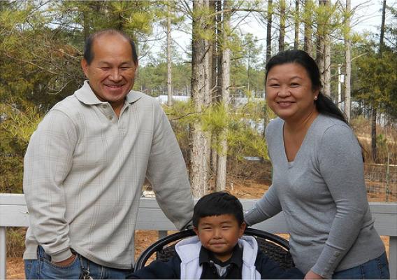 Maykia Yang (right), is trying to educate Hmong farmers in North Carolina about Farm Service Agency programs. Pictured with Maykia is her husband Jim (left) and son Marcus. 