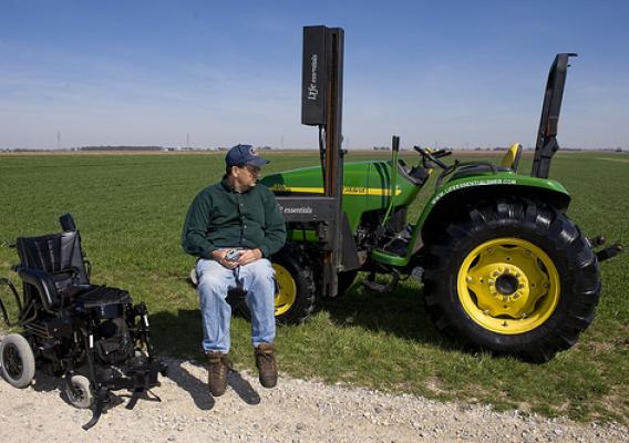 NIFA’s AgrAbilty Project recipient uses modified lift to transfer from wheelchair to tractor.  Photo credit:  National AgrAbility Project at Purdue University.
