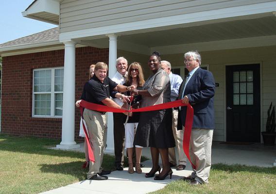 Mississippi Rural Development State Director Trina George (Third from right) helps cut a ribbon marking the opening of Rosedale Estates.