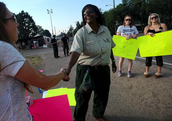 Jerri Marr, forest supervisor for the U.S. Forest Service, greets the crowd that gathered to thank the firefighters returning and leaving the fire camp Tuesday morning, July 3, 2012,  at Holmes Middle School in Colorado Springs, Colo. The Waldo Canyon Fire is now 70 percent contained.  (The Gazette, Christian Murdock) 