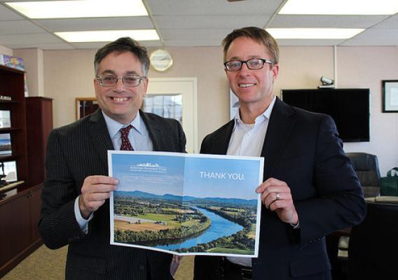American Farmland Trust President Andrew McElwaine presents NRCS Chief Jason Weller (right) with a thank you card with more than 1,300 signatures. NRCS photo.