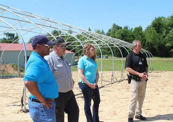NRCS staff discuss soil health efforts with Hopkins County jailer Joe Blue, right, and Deputy Jailer Billy Thomas and the jail’s gardener. NRCS photo by Christy Morgan.