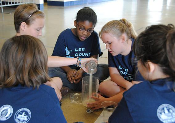 A group of students building a mini-filtration system